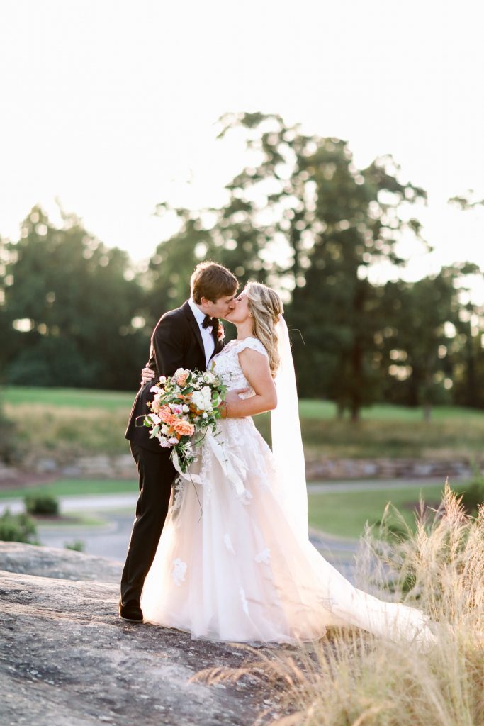 A Greenville wedding photographer photographs a couple during their Cliffs at Glassy Chapel wedding.