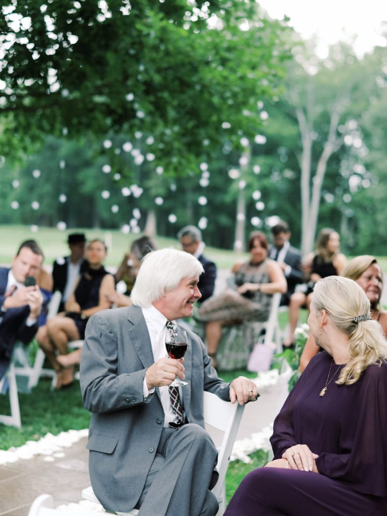 A Virginia film wedding photographer captures the elegant country club wedding ceremony at a Smith Mountain Lake wedding.