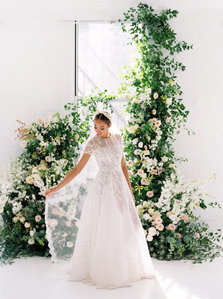 A bright floral bridal portrait session with a stylish Chana Marelus dress from Spina Bridal. Florals and styling by Kaleb Norman James, and photography by New York City film wedding photographer Lindley Battle.