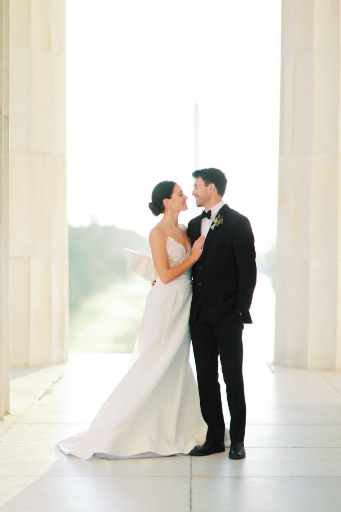 Romantic and modern DC wedding photography at the Lincoln Memorial, featuring a chic Oscar De La Renta wedding dress and a gorgeous bouquet from Sweet Root Village.