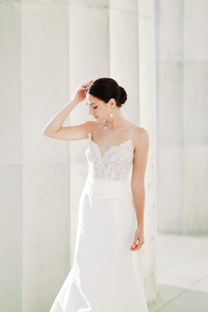 Romantic and modern DC wedding photography at the Lincoln Memorial, featuring a chic Oscar De La Renta wedding dress and a gorgeous bouquet from Sweet Root Village.