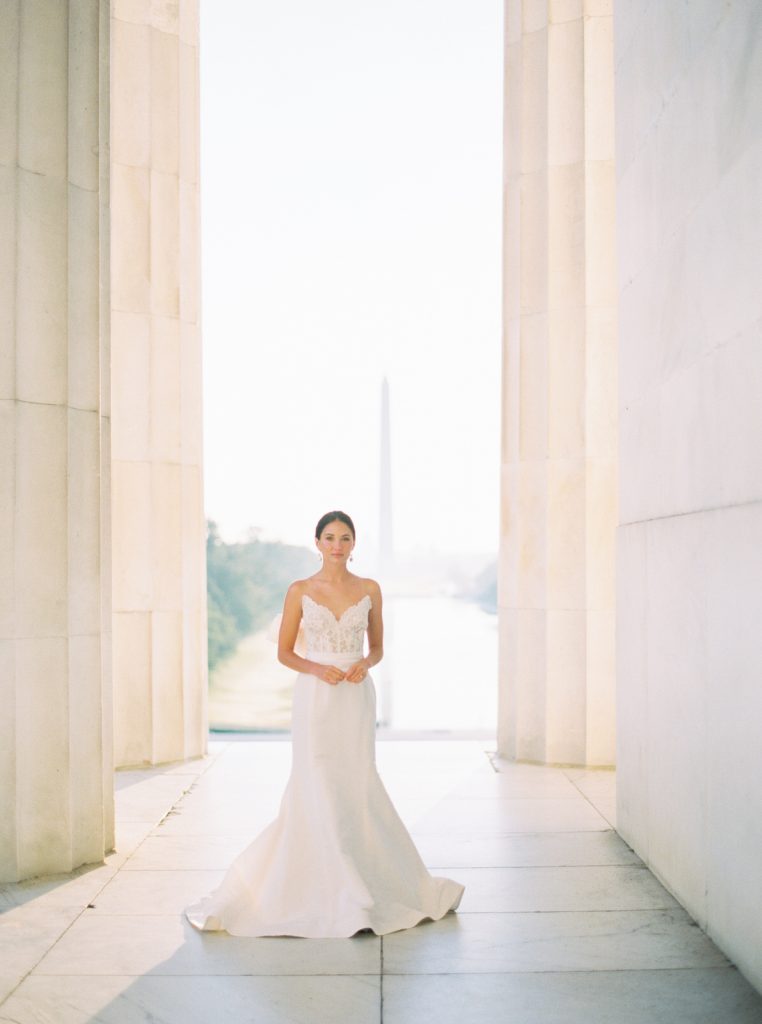 Romantic and modern DC wedding photography at the Lincoln Memorial, featuring a chic Oscar De La Renta wedding dress and a gorgeous bouquet from Sweet Root Village.