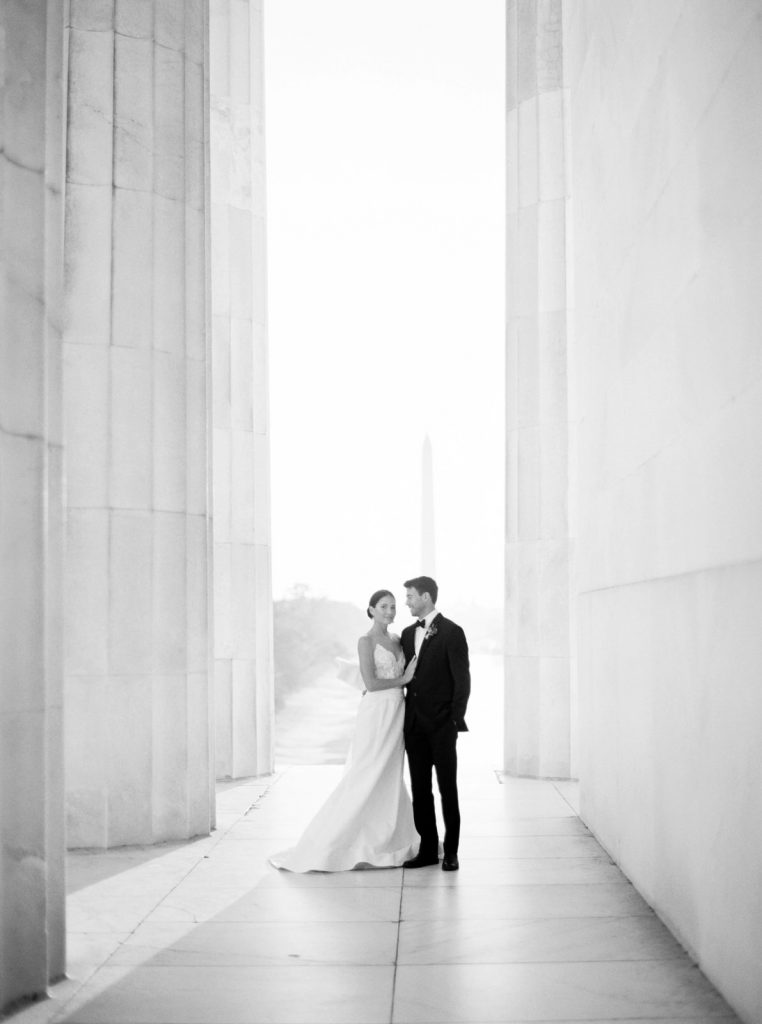 Romantic and modern DC wedding photography at the Lincoln Memorial, featuring a chic Oscar De La Renta wedding dress and a gorgeous bouquet from Sweet Root Village.