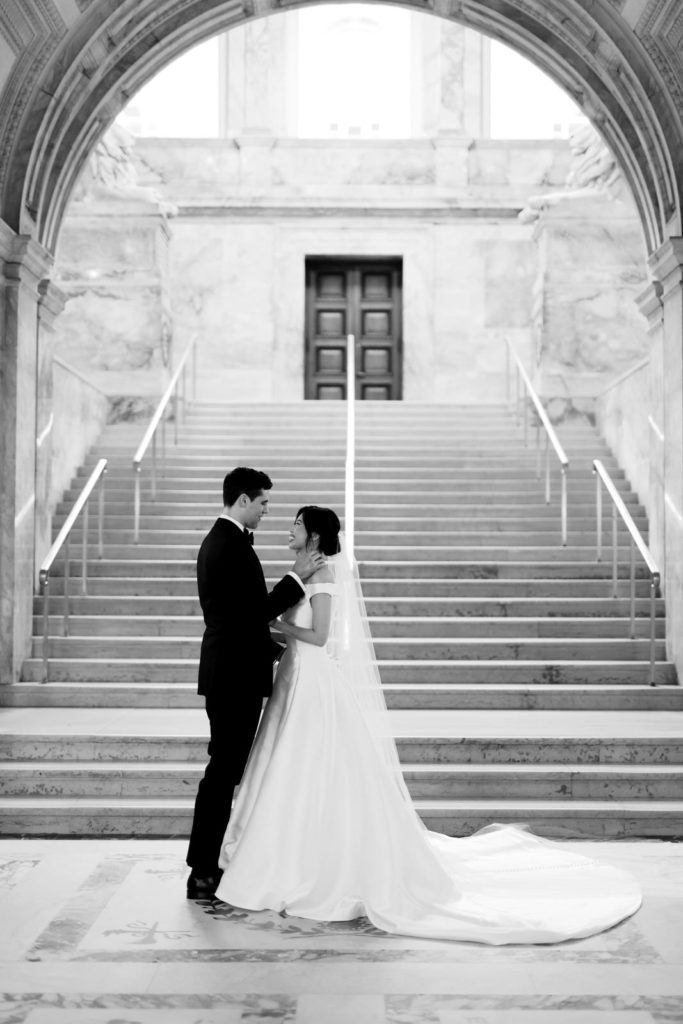 A wedding couple poses for photos at their Boston Public Library wedding.